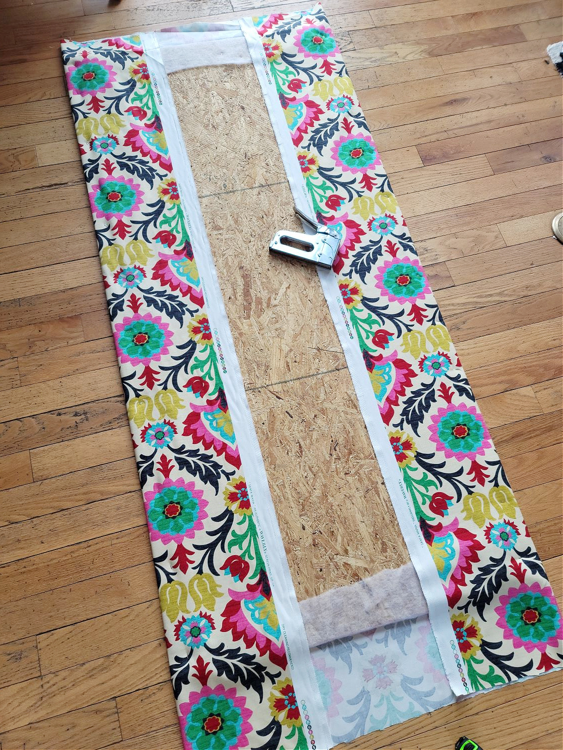 Upholstered Cabinet Panel by popular CO home design blog, Eclectic Twist: image of Waverly fabric stapled to a plywood board. 