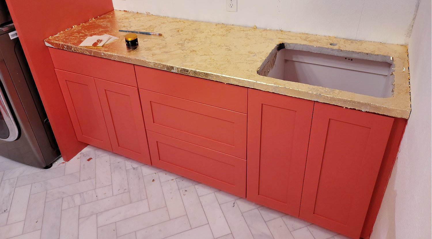 How to Gold Leaf by popular CO home design blog, Eclectic Twist: image of coral cabinets with a gold leaf countertop. 